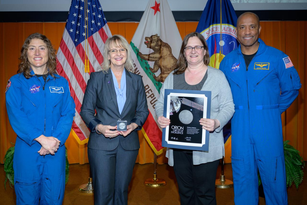 Artemis Orion Circle of Excellence Award presented to Kristina A. Skokova, center, by Orion Deputy Program Manager Debbie Korth, left, NASA astronauts Victor J. Glover, right, and Christina Koch, left, in the N201 auditorium.