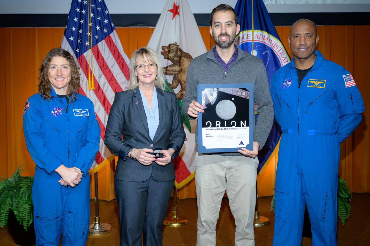 Artemis Orion program manager’s commendation award presented to Kyle Martin, center, by Orion Deputy Program Manager Debbie Korth, left, NASA astronauts Victor J. Glover, right, and Christina Koch, left, in the N201 auditorium.