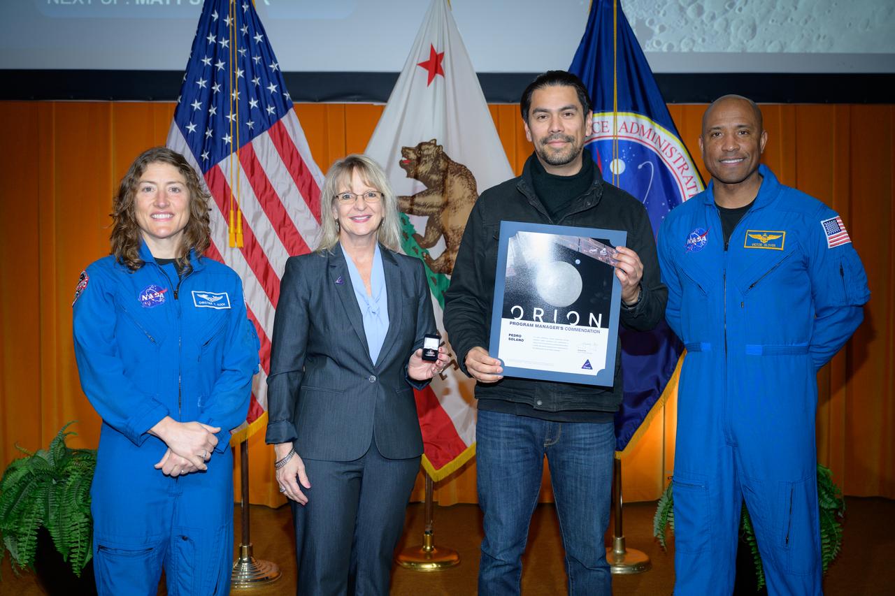 Artemis Orion program manager’s commendation award presented to Pedro Solano, center, by Orion Deputy Program Manager Debbie Korth, left, NASA astronauts Victor J. Glover, right, and Christina Koch, left, in the N201 auditorium.