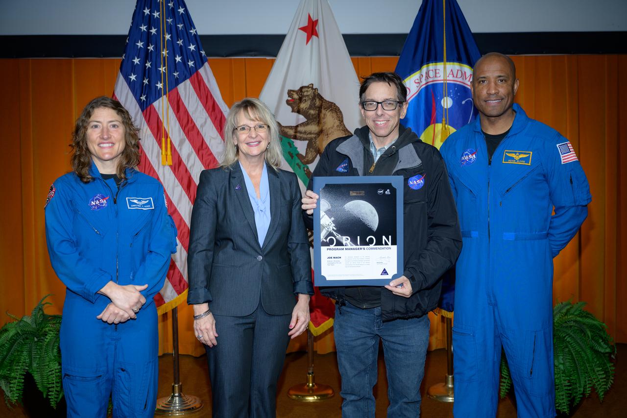 Artemis Orion program manager’s commendation team award presented to the Artemis I Investigation Arc Jet Test team accepted by Joe Mach, center, by Orion Deputy Program Manager Debbie Korth, left, NASA astronauts Victor J. Glover, right, and Christina Koch, left, in the N201 auditorium.