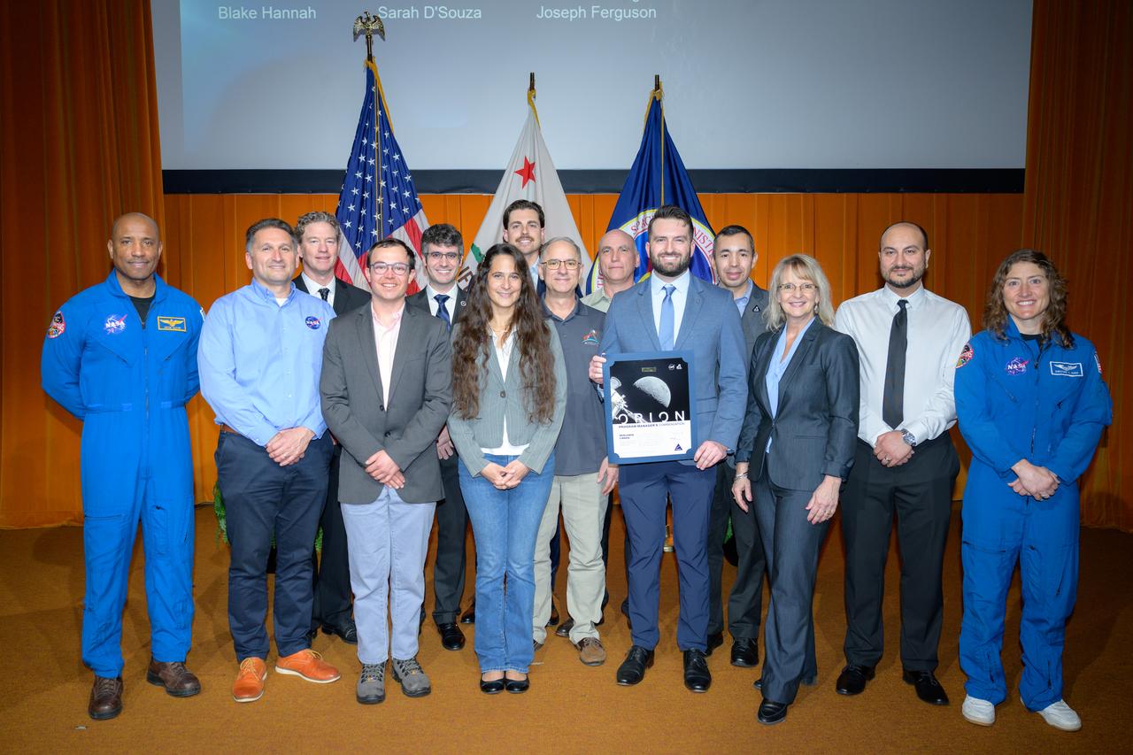Artemis I Heat Shield Sample Extraction and Analysis team with NASA astronauts Victor J. Glover, left, and Christina Koch, right, in the N201 auditorium.