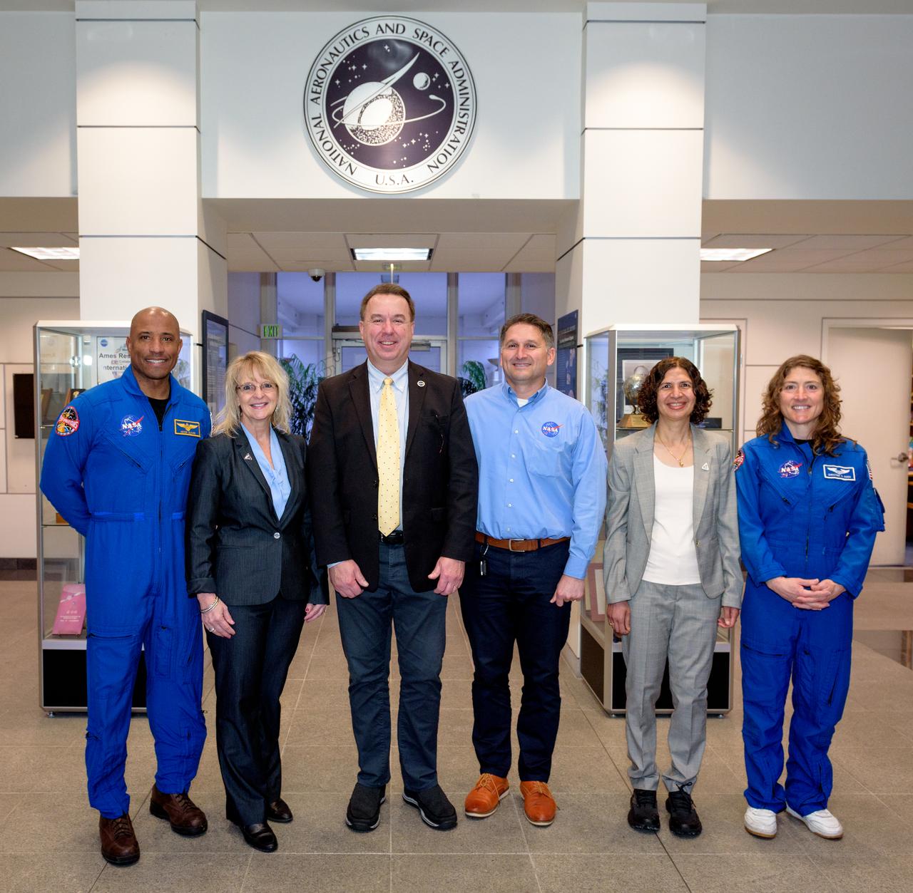 NASA astronaut Victor J. Glover, left, Orion Deputy Program Manager Debbie Korth, Deputy Center Director David Korsmeyer, Luis Saucedo, Parul Agrawal, and NASA astronaut Christina Koch, left, in the lobby of N200.