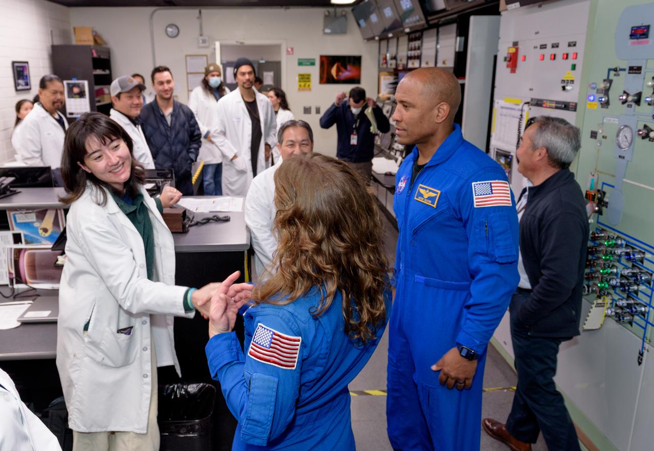 Amelia Kinsella, left, meets NASA astronauts Christina Koch and Victor J. Glover in the Ames Arc Jet control room for the Interaction Heating Facility (IHF), N238, where operators run the Arc Jet and review test data in real time.