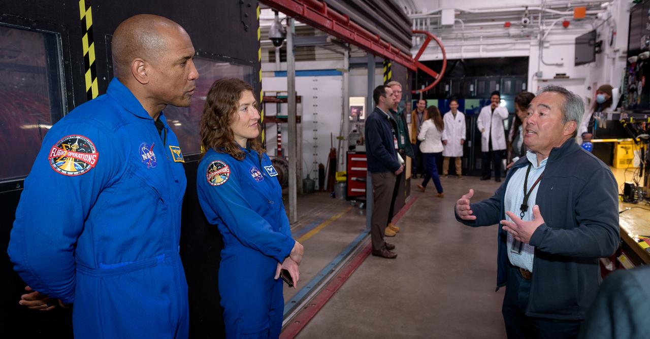 Thermophysics Facilities Branch Chief George Raiche, right, leads NASA astronauts Victor J. Glover, left, and Christina Koch through the Arc Jet Complex in N238.
