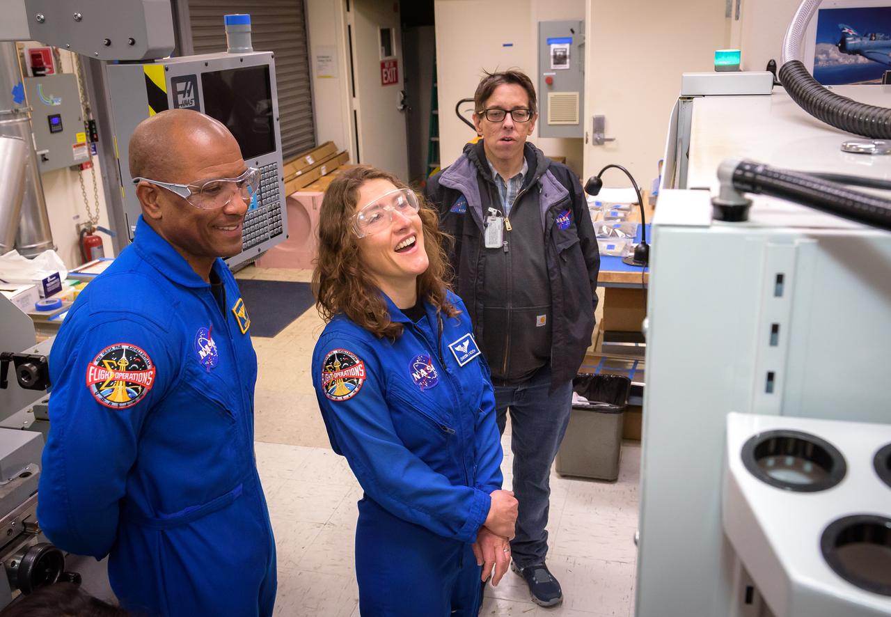 NASA astronauts Victor J. Glover, left, and Christina Koch, with Joe Mach as they tour STAR Labs, N238