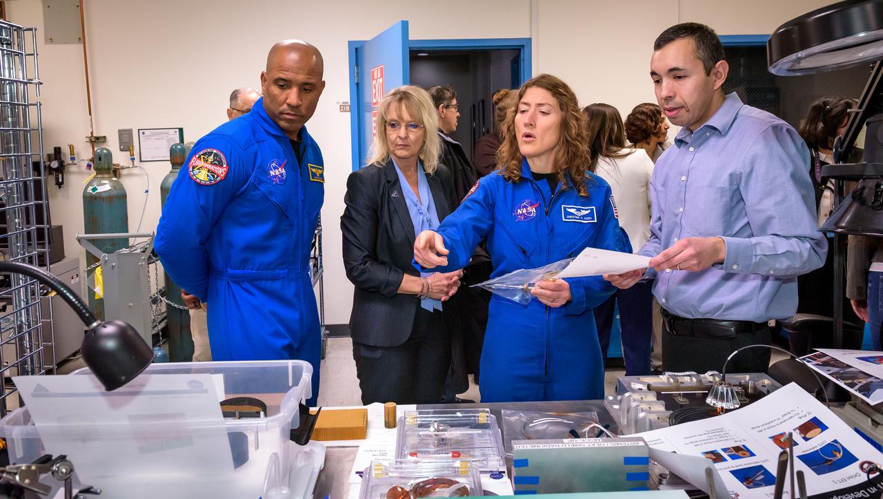 Jose A. B. Santos, right, discusses thermal protection materials with NASA astronaut Victor J. Glover, Orion Deputy Program Manager Debbie Korth, and NASA astronaut Christina Koch in STAR Labs in N242.