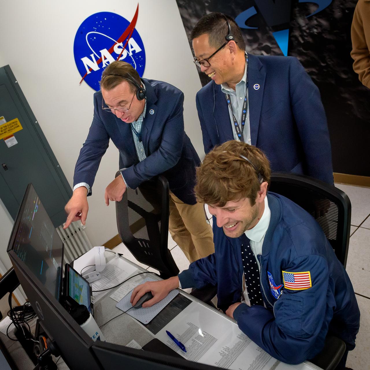 Volatiles Investigating Polar Exploration Rover (VIPER) vehicle operational readiness test in the Multi-Mission Operations Center (MMOC), N240A.  Jasper Wolfe, front, with David Korsmeyer, and Eugene Tu.