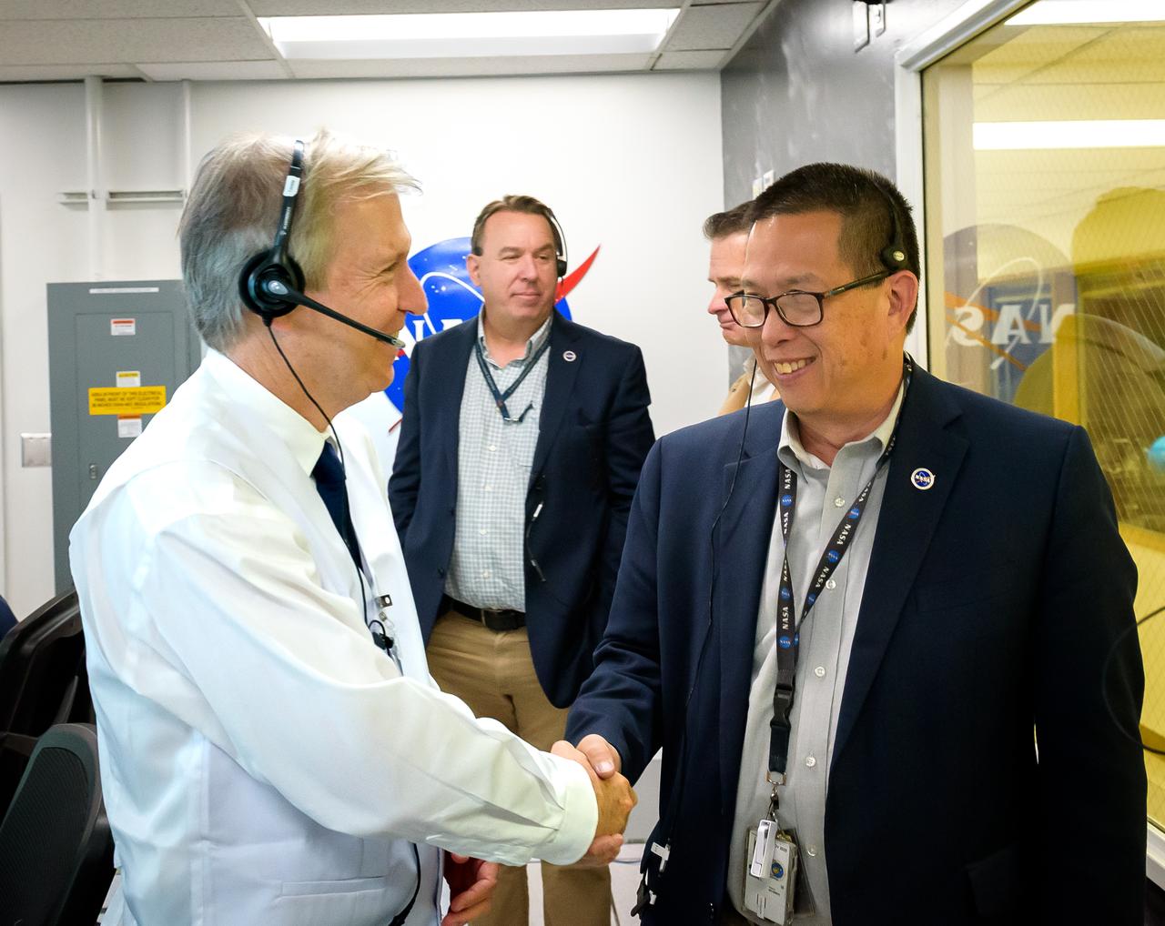 Volatiles Investigating Polar Exploration Rover (VIPER) mission systems manager Jay Trimble, left, with Center Director Eugene Tu during the vehicle operational readiness test in the Multi-Mission Operations Center (MMOC), N240A.  Deputy Center Director David Korsmeyer, behind.