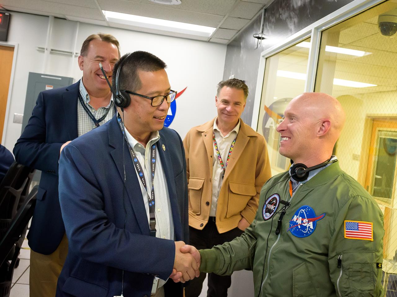 Center Director Eugene Tu, left, with Multi-Mission Operations Center (MMOC) Director Justin Pane during the Volatiles Investigating Polar Exploration Rover (VIPER) vehicle operational readiness test in the MMOC, N240A.  Deputy Center Director David Korsmeyer, back left, with VIPER Project Manager Daniel Andrews.