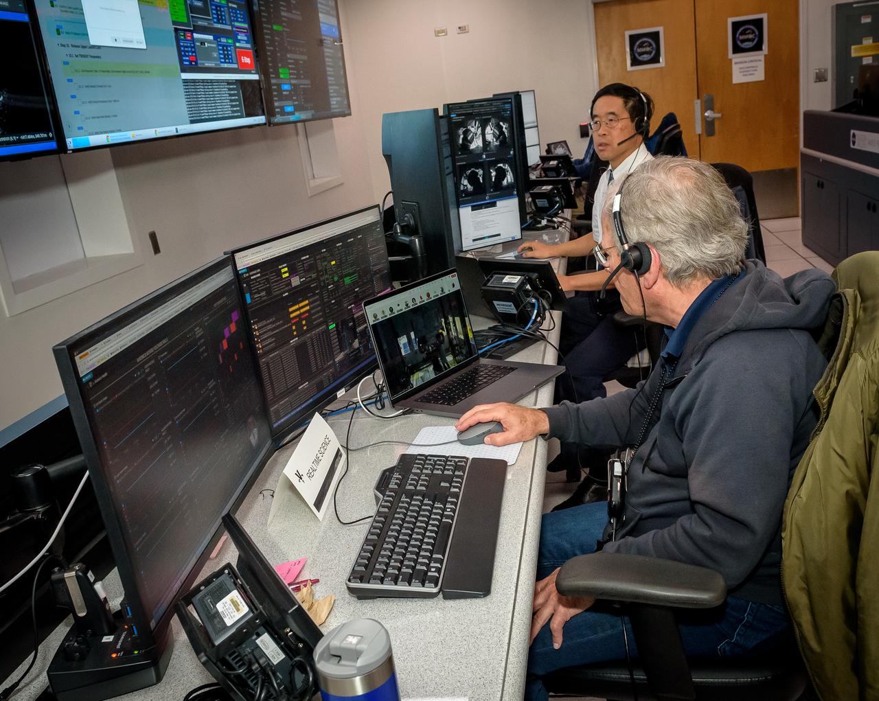 Rick Elphic, front, and Terry Fong, during the Volatiles Investigating Polar Exploration Rover (VIPER) vehicle operational readiness test in the Multi-Mission Operations Center (MMOC), N240A.