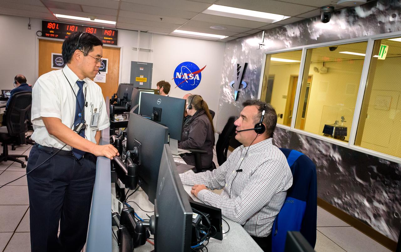 Terry Fong, left, and Chris Provencher during the Volatiles Investigating Polar Exploration Rover (VIPER) vehicle operational readiness test in the Multi-Mission Operations Center (MMOC), N240A.