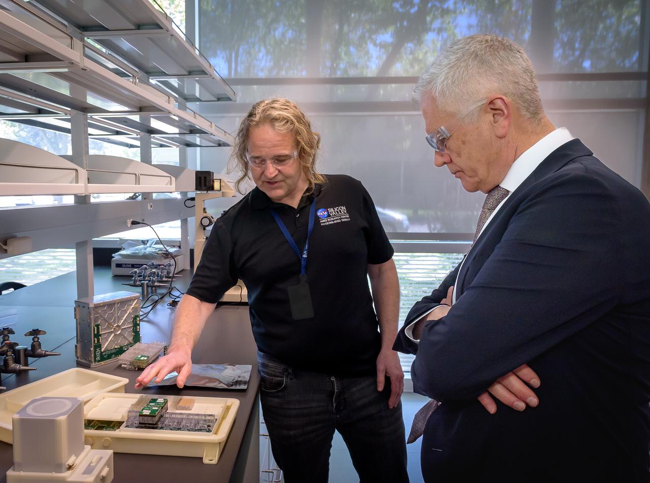 Director of Science Michael Hesse, left, presents an overview of Lunar Explorer Instrument for space biology Applications (LEIA) to Acting Deputy Associate Administrator (DAA) for the Science Mission Directorate (SMD) Mark Clampin in the Bioscience Collaborative Laboratory, N288.