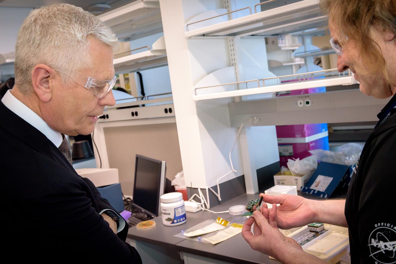 Director of Science Michael Hesse, right, presents an overview of Lunar Explorer Instrument for space biology Applications (LEIA) to Acting Deputy Associate Administrator (DAA) for the Science Mission Directorate (SMD) Mark Clampin in the Bioscience Collaborative Laboratory, N288.