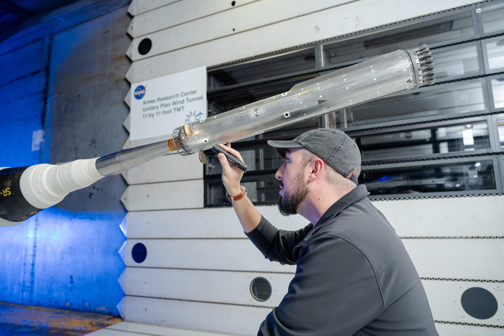 These photos show how engineers with conducted testing on a 1.2% scale model of SpaceX’s Super Heavy Version 3 rocket booster at NASA’s Ames Research Center in California’s Silicon Valley. The tests focused on better understanding the extreme aerodynamic forces the rocket can experience during re-entry and builds on a previous test series completed at NASA Ames in 2024.  NASA is working with SpaceX to develop the company’s Starship Human Landing System (HLS) to safely carry astronauts from lunar orbit to the Moon’s surface and back. The upgraded Super Heavy rocket booster is part of SpaceX’s Starship launch system.  