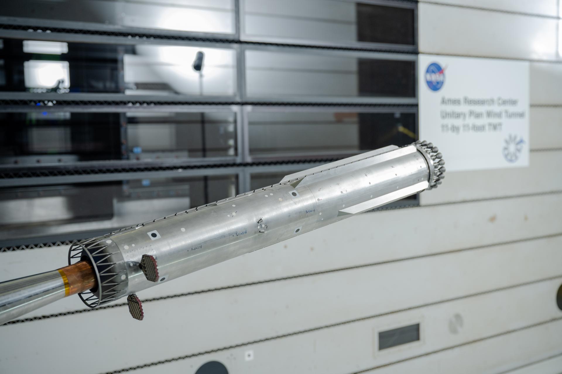 These photos show how engineers with conducted testing on a 1.2% scale model of SpaceX’s Super Heavy Version 3 rocket booster at NASA’s Ames Research Center in California’s Silicon Valley. The tests focused on better understanding the extreme aerodynamic forces the rocket can experience during re-entry and builds on a previous test series completed at NASA Ames in 2024.  NASA is working with SpaceX to develop the company’s Starship Human Landing System (HLS) to safely carry astronauts from lunar orbit to the Moon’s surface and back. The upgraded Super Heavy rocket booster is part of SpaceX’s Starship launch system. 