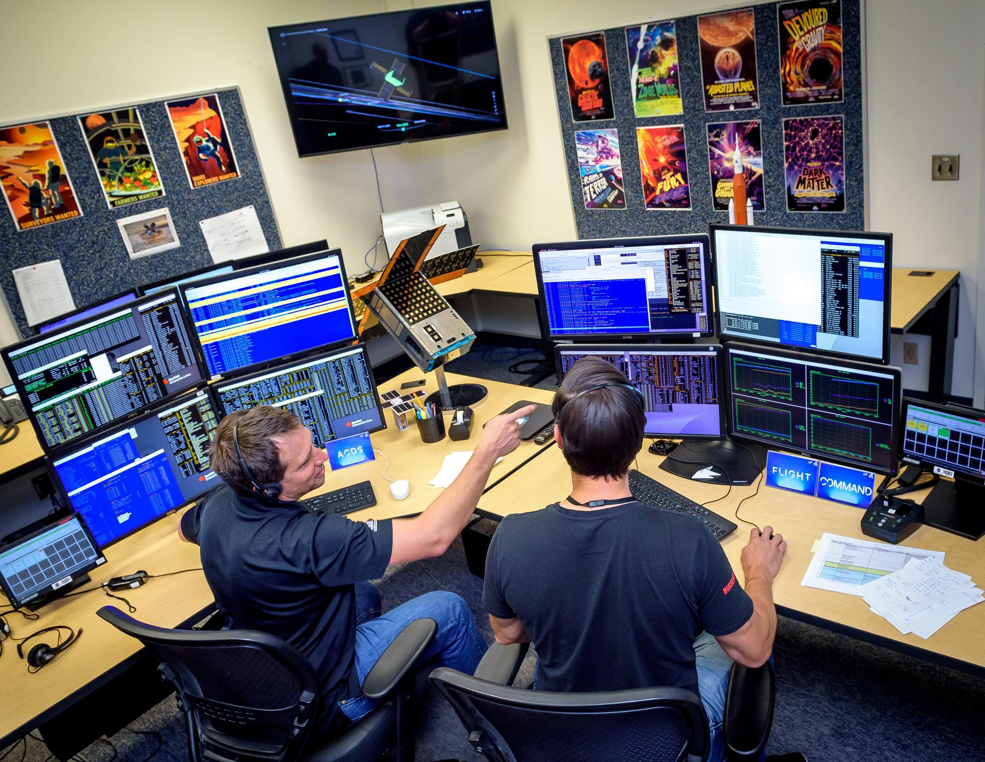 Jesse Fusco, left, and James Milsk at the BioSentinel command console in the Ames Multi-Mission Operations Center (MMOC), N240 Annex, Ceres control room 172, receiving spacecraft telemetry at the 3-year anniversary since launch on Artemis I.