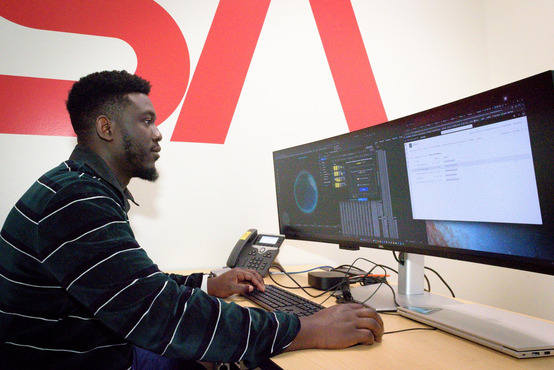 TechEdSat-11 operator Kwabena Boateng, in the Ames Multi-Mission Operations Center (MMOC), N240 Annex, Eros control room 162. Kwabena monitors the spacecraft's status during the Exo-Brake “parachute” deployment.   The ExoBrake is a drag device that increases the total surface area of the spacecraft to assist with a quicker deorbit. This maneuver is deployed at the end of mission to satisfy NASA's deorbit requirement and prevent space debris. TechEdSat has spent the last several months coordinating with NASA’s Conjunction Assessment Risk Analysis (CARA) team to ensure the spacecraft can safely deploy the ExoBrake without colliding into any other objects.
