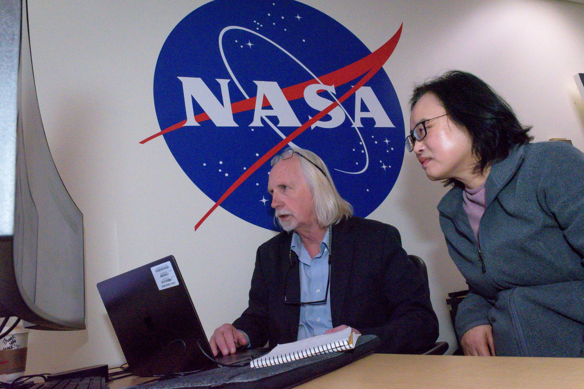 TechEdSat-11 operators Marcus Murbach, left, and Kyeong Ja Kim, in the Ames Multi-Mission Operations Center (MMOC), N240 Annex, Eros control room 162. The team monitors the spacecraft's status during the Exo-Brake “parachute” deployment.   The ExoBrake is a drag device that increases the total surface area of the spacecraft to assist with a quicker deorbit. This maneuver is deployed at the end of mission to satisfy NASA's deorbit requirement and prevent space debris. TechEdSat has spent the last several months coordinating with NASA’s Conjunction Assessment Risk Analysis (CARA) team to ensure the spacecraft can safely deploy the ExoBrake without colliding into any other objects.