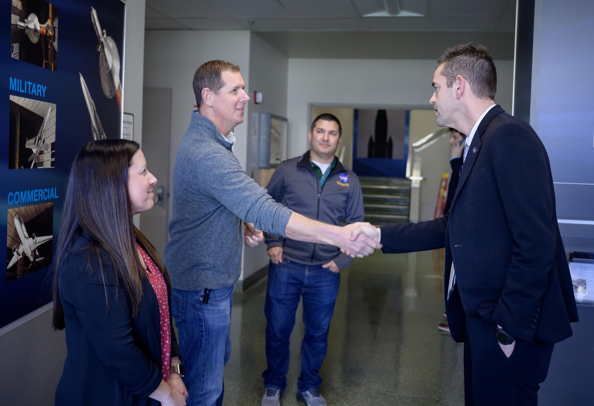 Wind tunnel staff Mike Treece and Wind Tunnel Division Chief Maureen Delgado greet NASA Administrator Jared Isaacman in the lobby of the Unitary Plan Wind Tunnel (UPWT) facility in N227. 