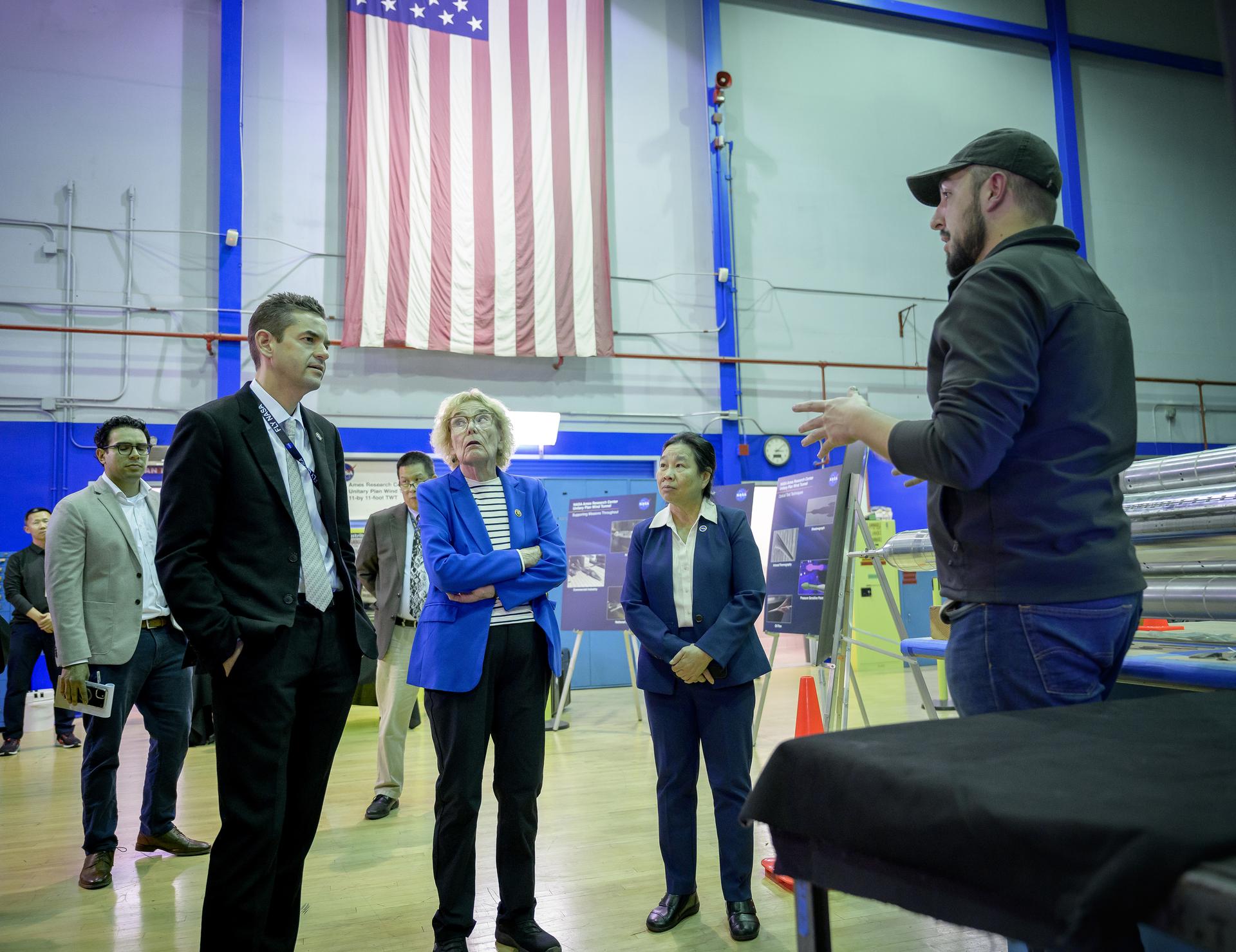 NASA Administrator Jared Isaacman, left, Congresswoman Zoe Lofgren, and Director of Aeronautics Huy Tran, right, tour the Unitary Plan Wind Tunnel (UPWT) facility in N227.