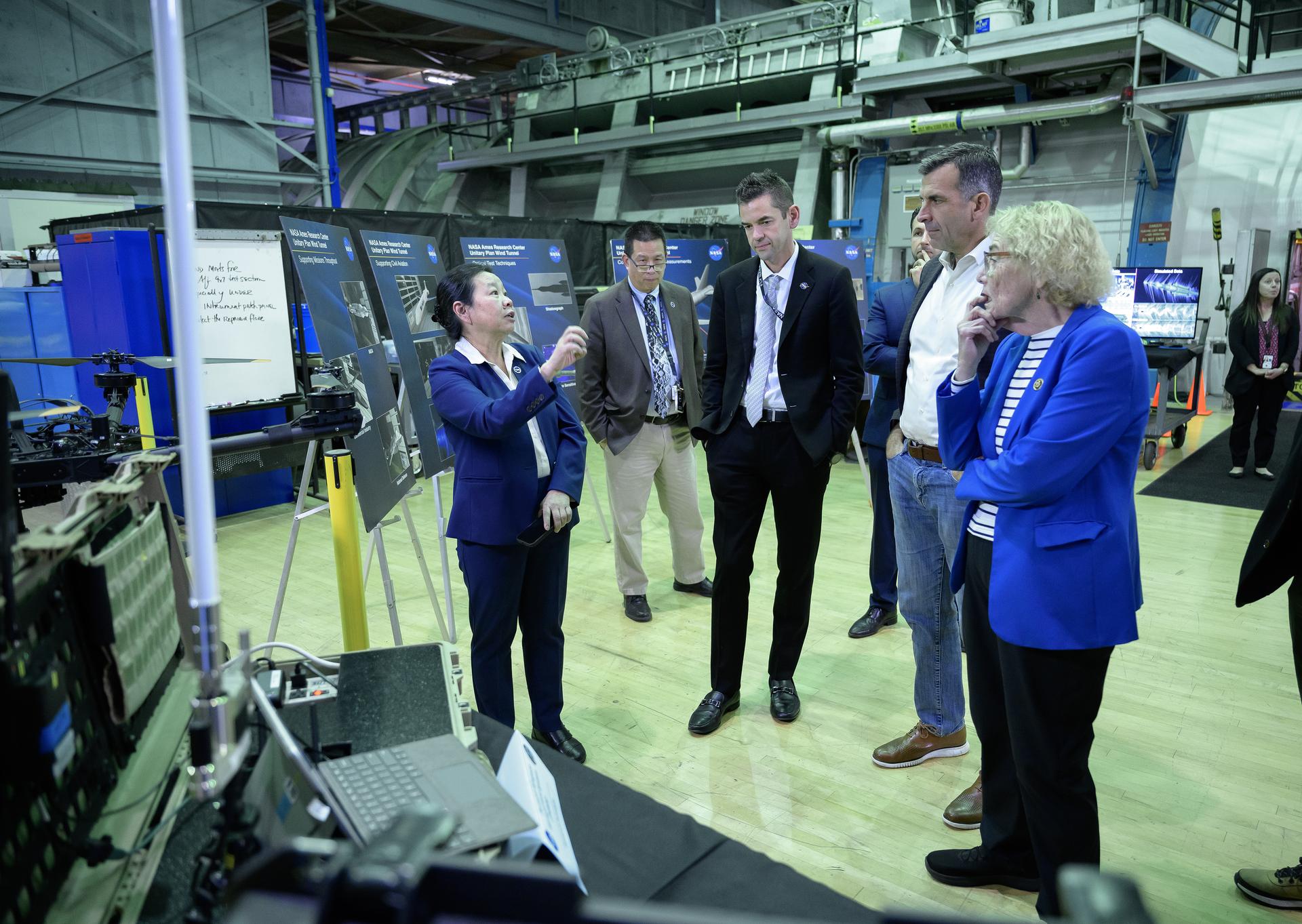 Director of Aeronautics Huy Tran, left, speaks to NASA Administrator Jared Isaacman, Congressman Sam Liccardo, and Congresswoman Zoe Lofgren, right, with Center Director Eugene Tu looking on in the back. 