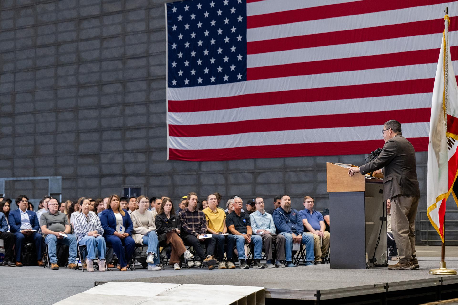 Center Director Eugene Tu speaks at the NASA Civil Servant Swearing-in Ceremony in the National Full-Scale Aerodynamics Complex (NFAC) 80-by-120-foot test section, N221.