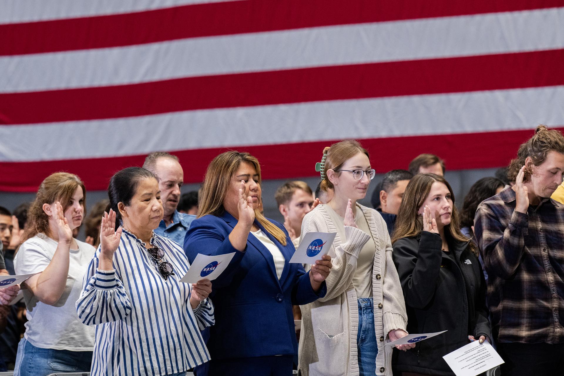 Participants stand while Associate Administrator Amit Kshatriya administers the Oath of Office during the NASA Civil Servant Swearing-in Ceremony in the National Full-Scale Aerodynamics Complex (NFAC) 80-by-120-foot test section, N221.