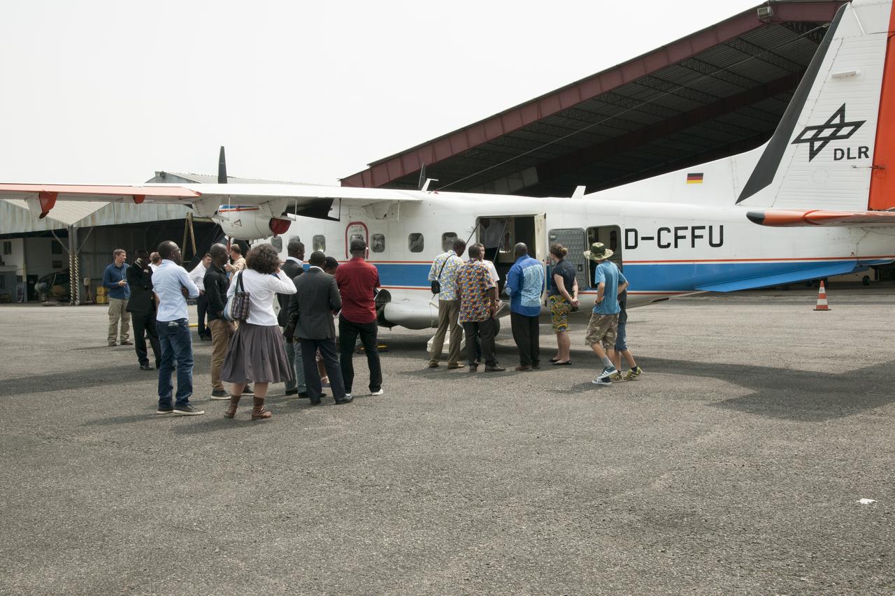 During an education outreach event in Gabon, Africa, students and educators, look at the German Aerospace Center Dornier DO-228 twin-engine turboprop aircraft.