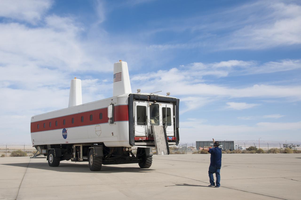 Workers drive the space shuttle Crew Transport Vehicle, or CTV, to the Edwards Air Force Base Flight Test Museum in California for display.