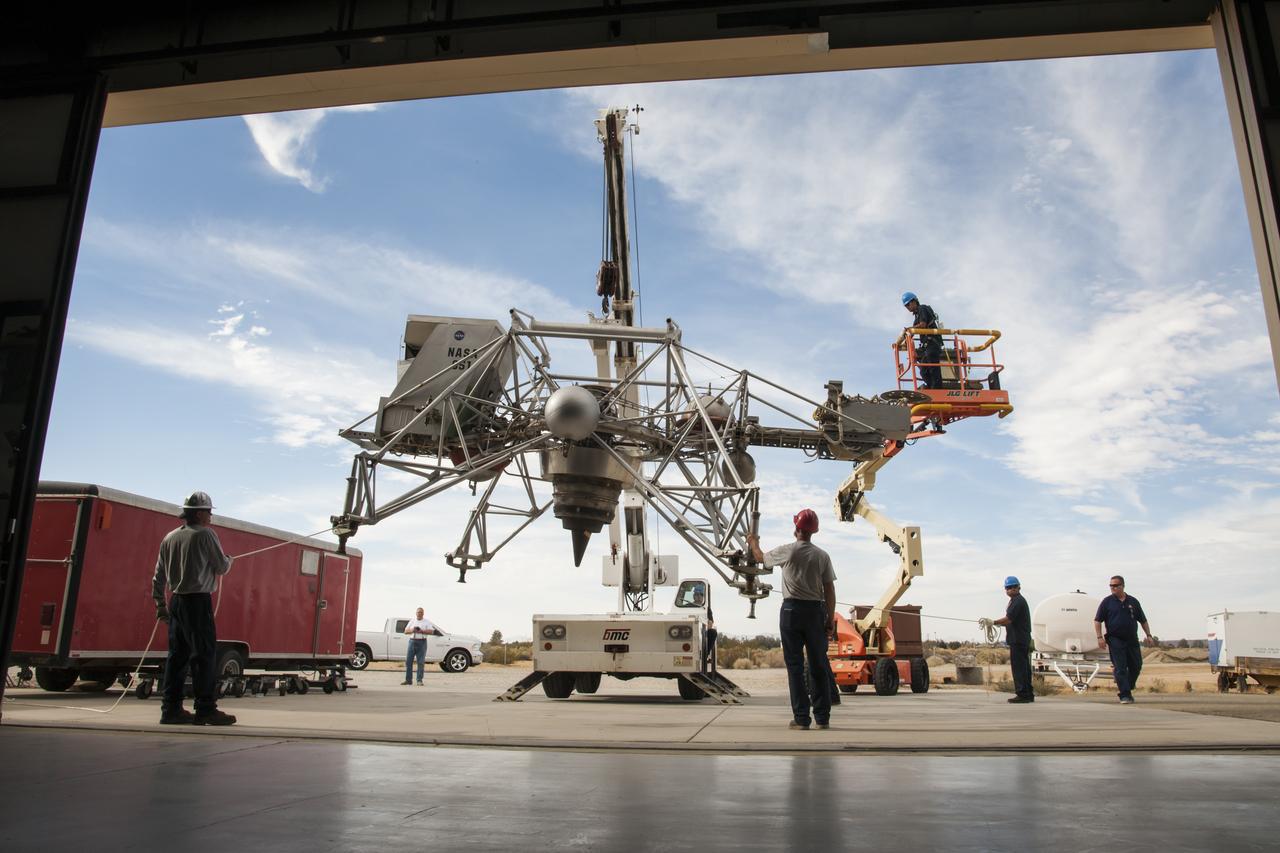 Workers move the Lunar Landing Research Vehicle, or LLRV, into the Edwards Air Force Base Flight Test Museum in California for temporary display.