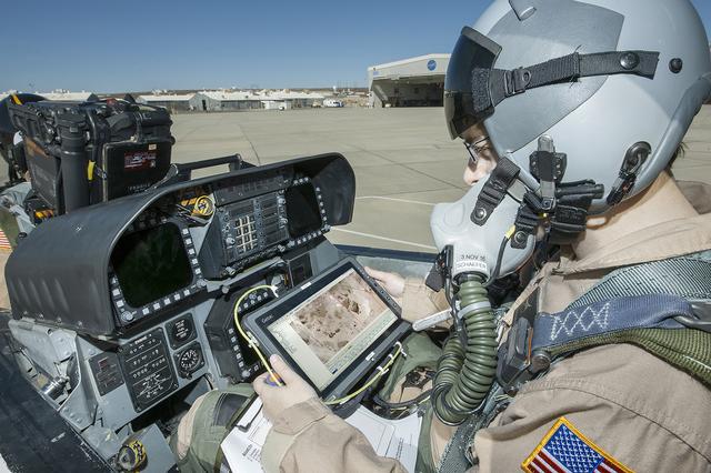 Flight Test Engineer Jacob Schaefer inspects the Cockpit Interactive Sonic Boom Display Avionics, or CISBoomDA, from the cockpit of his F-18 at NASA’s Armstrong Flight Research Center in Edwards, California.