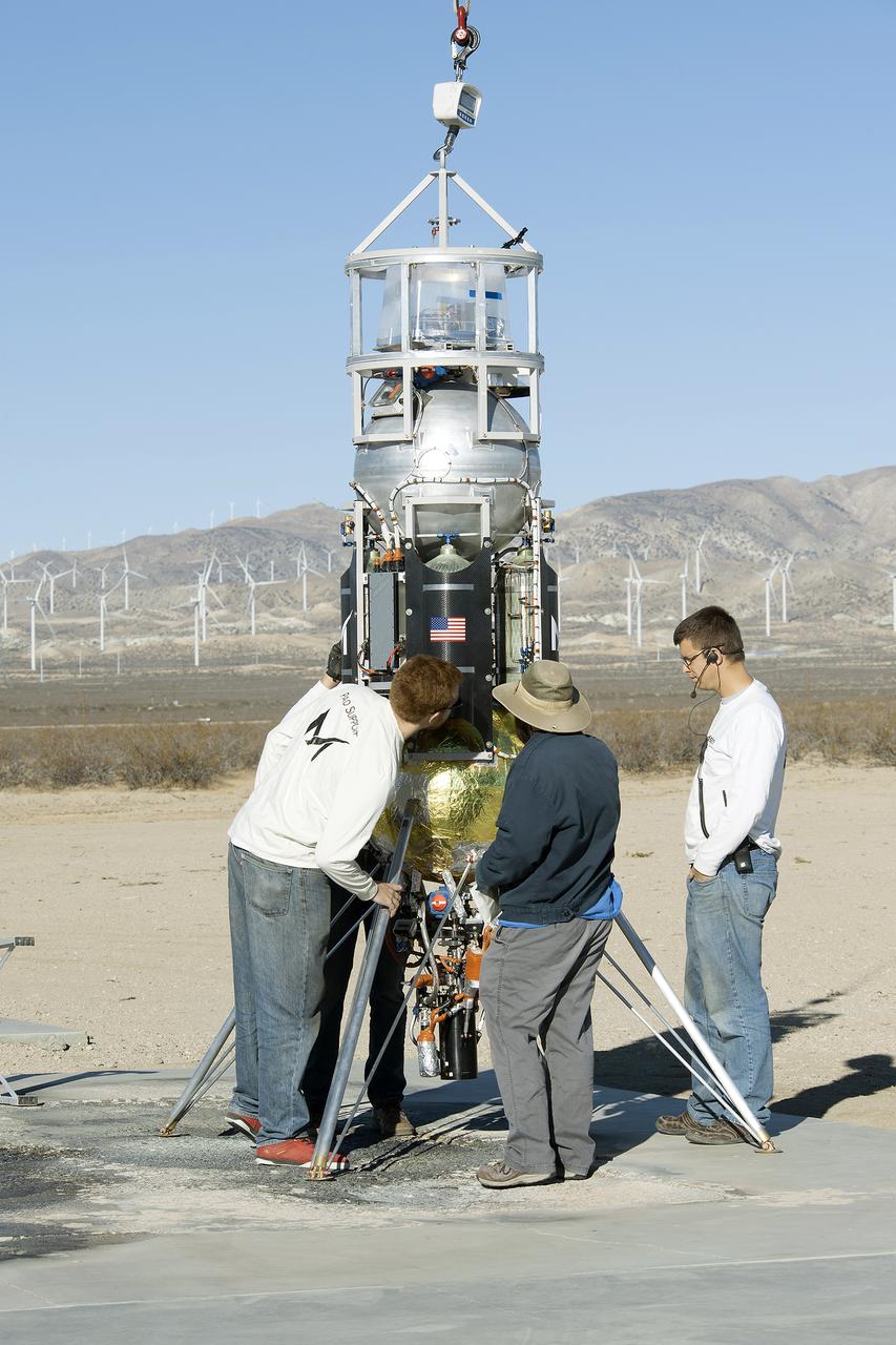 From left to right Masten employees, Luke Farrell, Richard Garcia and intern Alex Drozda employees prepare Xodiac rocket to flight test JHU APL technology.