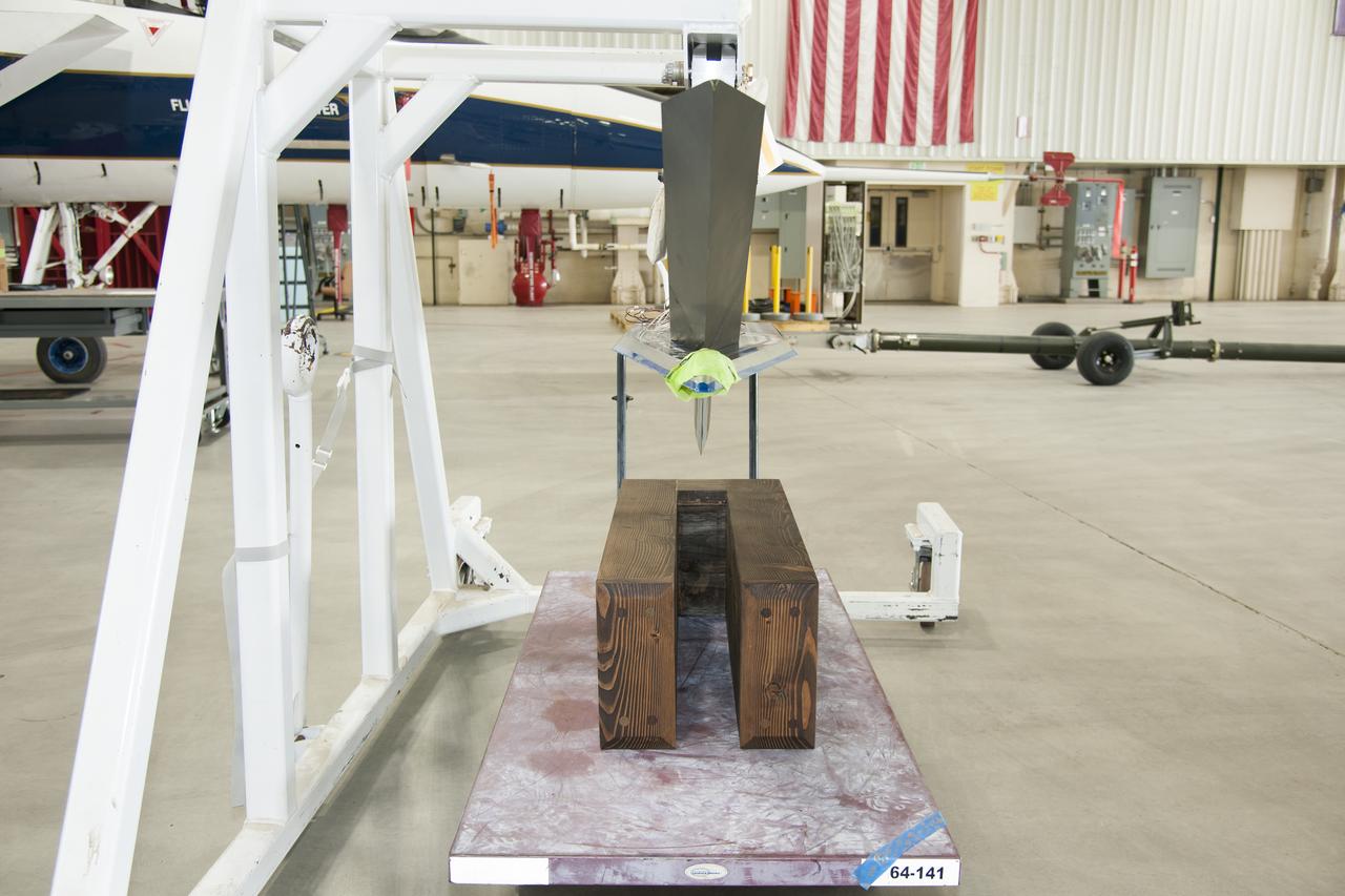 Testing different configurations of distributed roughness elements on the Swept Wing Laminar Flow test article, seen suspended above, will allow NASA researchers to observe which distributions are most efficient in extending laminar flow over a supersonic aircraft’s wing.