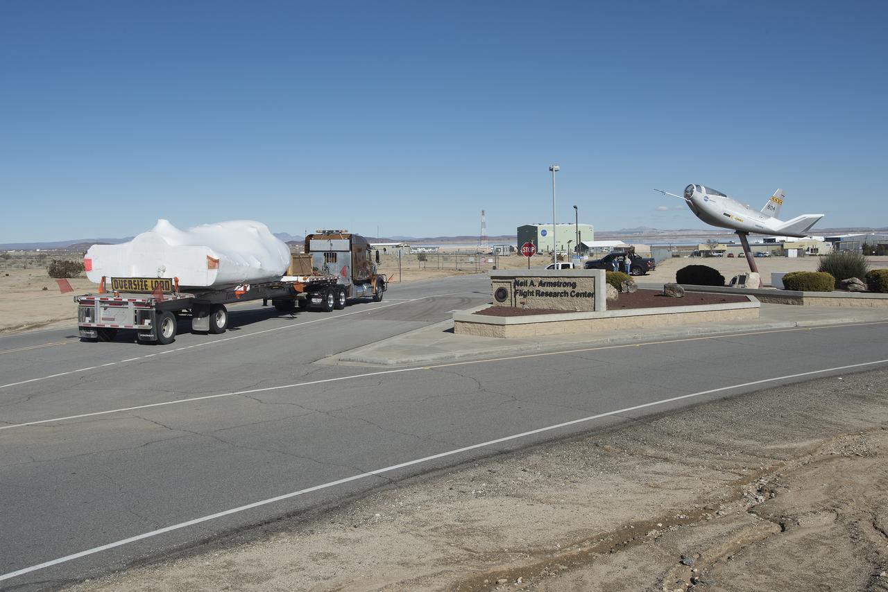 Sierra Nevada Corporation’s Dream Chaser spacecraft arrives by truck at NASA’s Armstrong Flight Research Center in California, located on Edwards Air Force Base. The spacecraft will undergo several months of testing in preparation for its approach and landing flight on the base’s 22L runway. The test series is part of a developmental space act agreement SNC has with NASA’s Commercial Crew Program and will help SNC validate aerodynamic properties, flight software and control system performance. The Dream Chaser is also being prepared to deliver cargo to the International Space Station under NASA’s Commercial Resupply Services 2 contract beginning in 2019. The cargo Dream Chaser will fly at least six delivery missions to and from the space station by 2024.