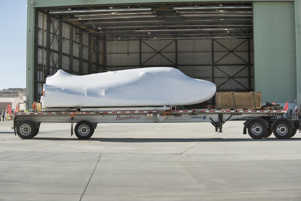 Sierra Nevada Corporation’s Dream Chaser spacecraft arrives by truck at NASA’s Armstrong Flight Research Center in California, located on Edwards Air Force Base. The spacecraft will undergo several months of testing in preparation for its approach and landing flight on the base’s 22L runway. The test series is part of a developmental space act agreement SNC has with NASA’s Commercial Crew Program and will help SNC validate aerodynamic properties, flight software and control system performance. The Dream Chaser is also being prepared to deliver cargo to the International Space Station under NASA’s Commercial Resupply Services 2 contract beginning in 2019. The cargo Dream Chaser will fly at least six delivery missions to and from the space station by 2024.