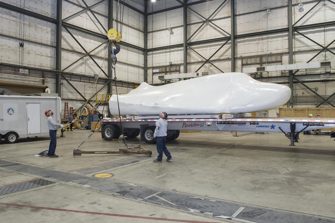 Sierra Nevada Corporation’s Dream Chaser spacecraft arrives by truck at NASA’s Armstrong Flight Research Center in California, located on Edwards Air Force Base. The spacecraft will undergo several months of testing in preparation for its approach and landing flight on the base’s 22L runway. The test series is part of a developmental space act agreement SNC has with NASA’s Commercial Crew Program and will help SNC validate aerodynamic properties, flight software and control system performance. The Dream Chaser is also being prepared to deliver cargo to the International Space Station under NASA’s Commercial Resupply Services 2 contract beginning in 2019. The cargo Dream Chaser will fly at least six delivery missions to and from the space station by 2024.