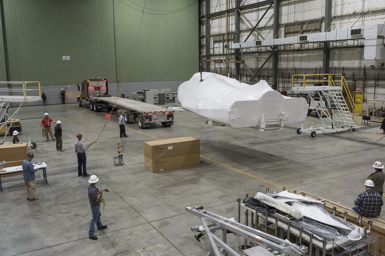 Sierra Nevada Corporation’s Dream Chaser spacecraft is removed from its delivery truck after arriving at NASA’s Armstrong Flight Research Center in California, located on Edwards Air Force Base. The spacecraft will undergo several months of testing in preparation for its approach and landing flight on the base’s 22L runway. The test series is part of a developmental space act agreement SNC has with NASA’s Commercial Crew Program and will help SNC validate aerodynamic properties, flight software and control system performance. The Dream Chaser is also being prepared to deliver cargo to the International Space Station under NASA’s Commercial Resupply Services 2 contract beginning in 2019. The cargo Dream Chaser will fly at least six delivery missions to and from the space station by 2024.