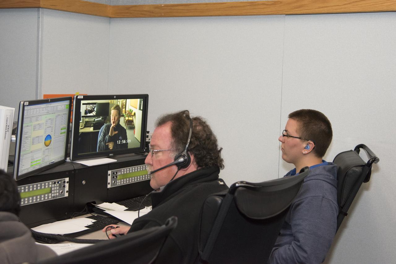 Johanna Lucht, observing data from the Mission Control Center at NASA’s Armstrong Flight Research Center in California, received flight communications from an interpreter, seen on Lucht’s monitor, through American Sign Language. Two-way visual communication was established between Lucht and the interpreter, located at NASA’s Langley Research Center in Virginia, for the flight. Interpreting technical terminology often requires cooperation to develop specific signs to ease communication. Using a familiar interpreter who is adept or practiced in the technical terminology of a NASA flight was beneficial, Lucht says.