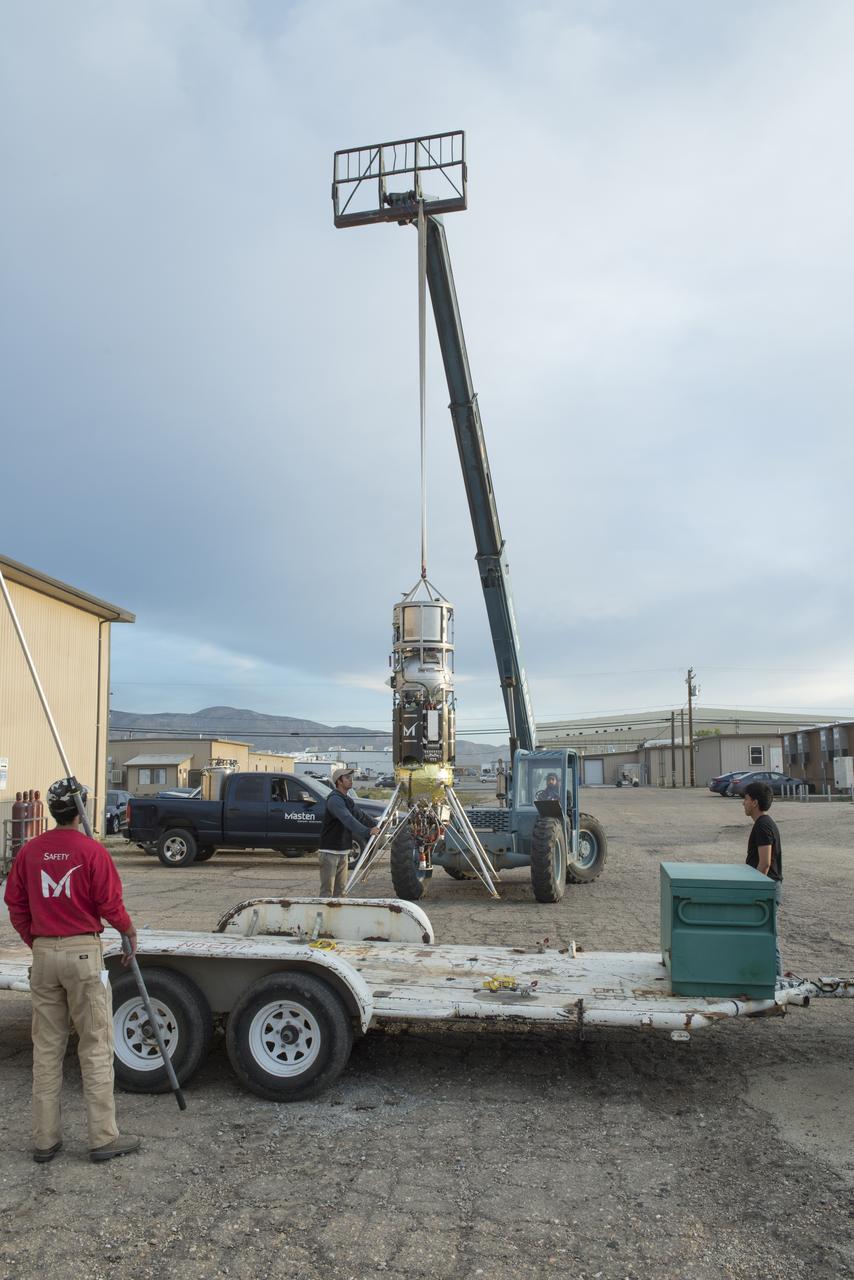 Masten Space Systems’ technician making adjustments to NASA’s autonomous landing technologies payload on Masten’s Xodiac rocket.