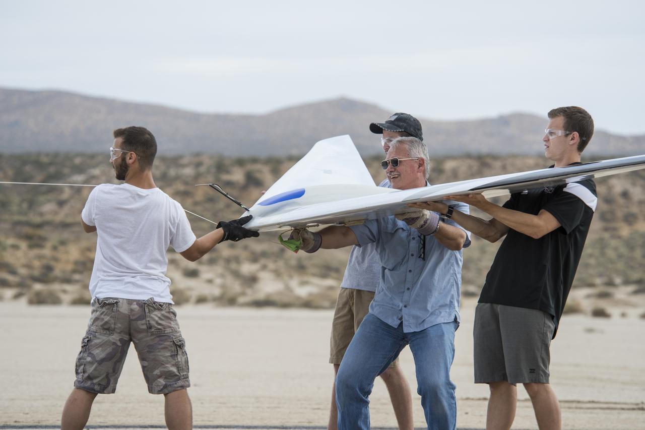 Al Bowers, center, and a group of student interns hook up a bungee cord for a flight of the Prandtl-D 3C subscale glider aircraft.