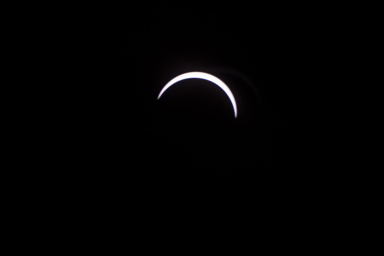 The Moon is seen passing in front of the Sun during a total solar eclipse on Monday, August 21, 2017 from onboard a NASA Gulfstream III aircraft flying 25,000 feet above the Oregon coast. A total solar eclipse swept across a narrow portion of the contiguous United States from Lincoln Beach, Oregon to Charleston, South Carolina. A partial solar eclipse was visible across the entire North American continent along with parts of South America, Africa, and Europe.  Photo Credit: (NASA/Carla Thomas)
