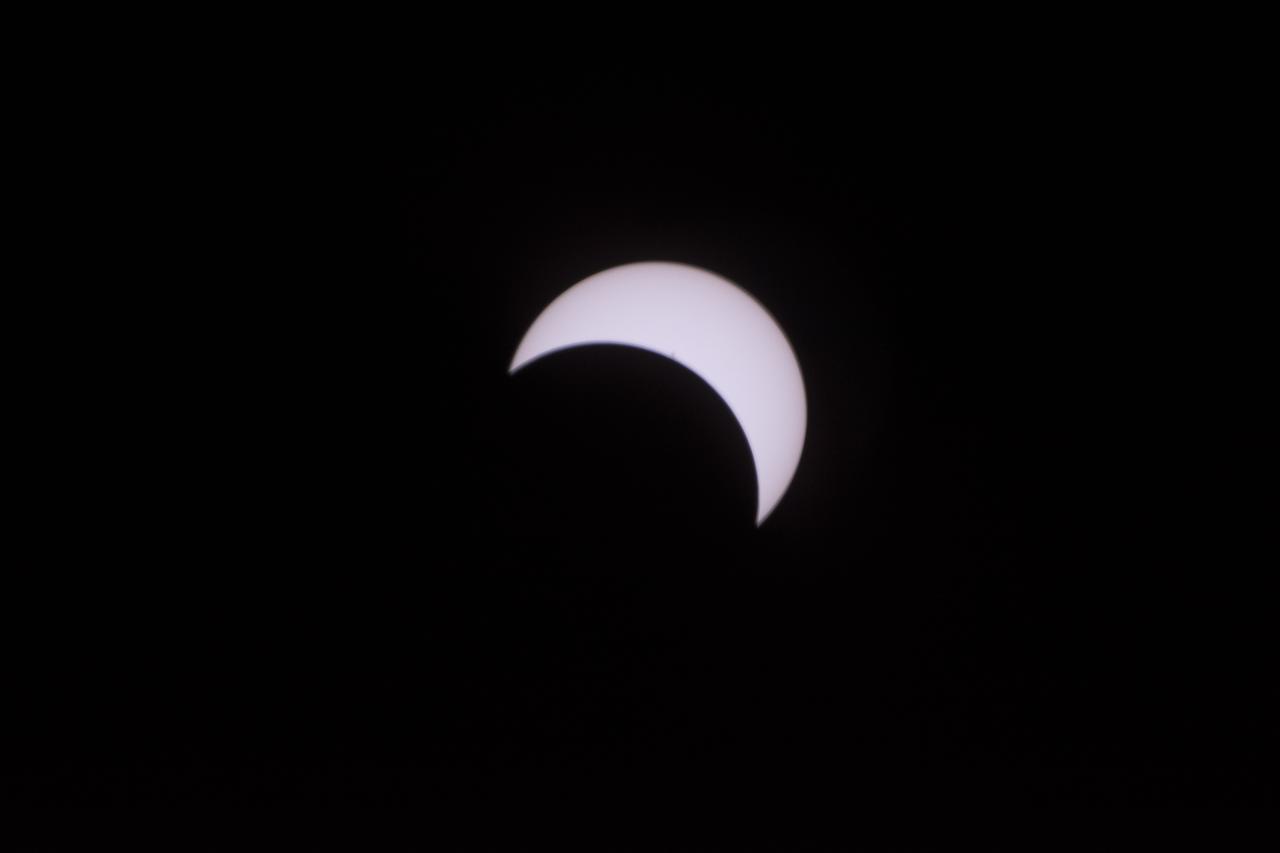 The Moon is seen passing in front of the Sun during a total solar eclipse on Monday, August 21, 2017 from onboard a NASA Gulfstream III aircraft flying 25,000 feet above the Oregon coast. A total solar eclipse swept across a narrow portion of the contiguous United States from Lincoln Beach, Oregon to Charleston, South Carolina. A partial solar eclipse was visible across the entire North American continent along with parts of South America, Africa, and Europe.  Photo Credit: (NASA/Carla Thomas)