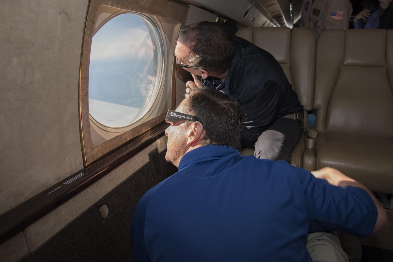Robert Lightfoot, acting NASA administrator and Thomas Zurbuchen NASA AA for the science mission directorate view a partial eclipse solar eclipse Monday, August 21, 2017, from onboard a NASA Armstrong Flight Research Center’s Gulfstream III 35,000 feet above the Oregon Coast. A total solar eclipse swept across a narrow portion of the contiguous United States from Lincoln Beach, Oregon to Charleston, South Carolina. Photo Credit: (NASA/Carla Thomas)