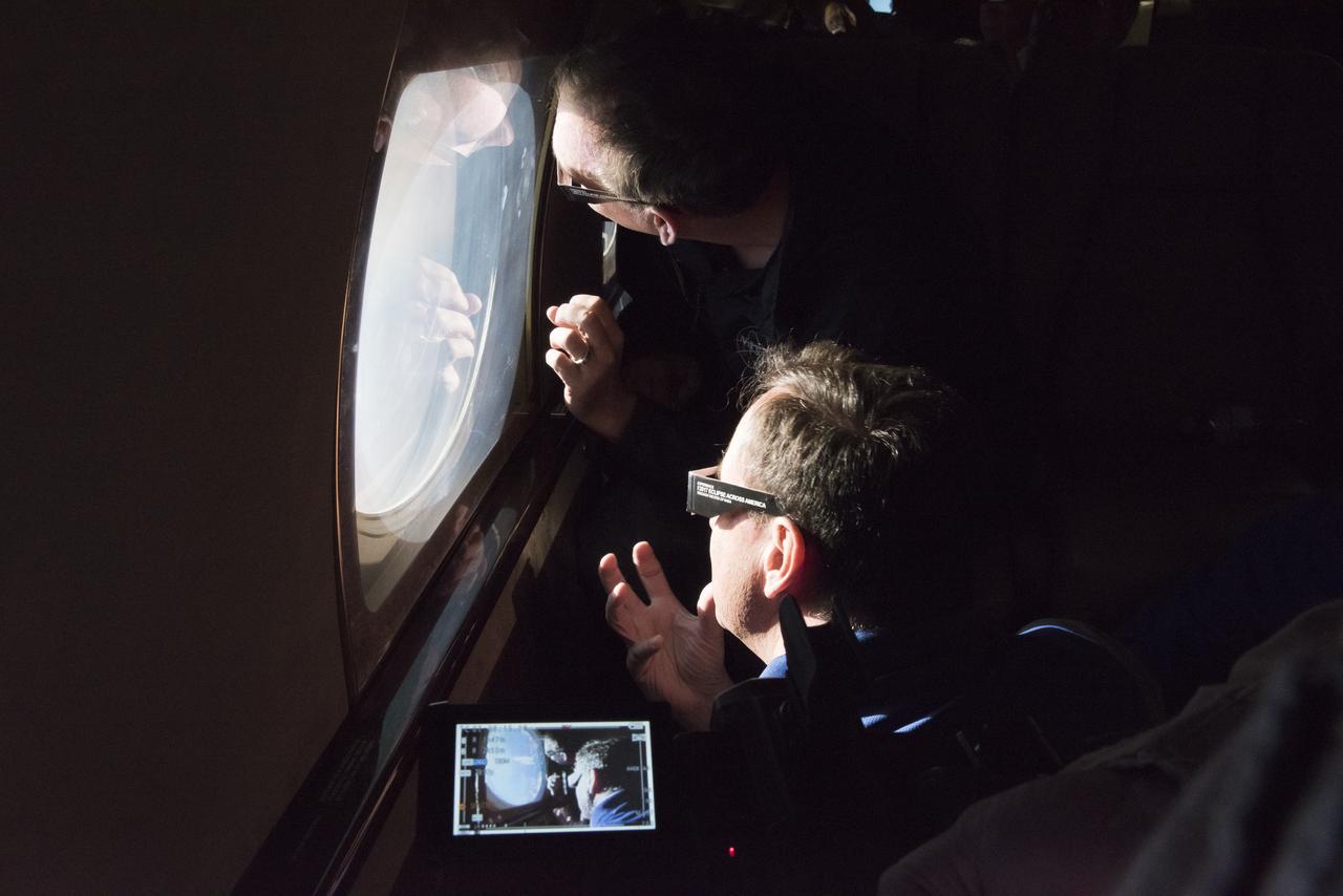 Robert Lightfoot, acting NASA administrator and Thomas Zurbuchen NASA AA for the science mission directorate view a partial eclipse solar eclipse Monday, August 21, 2017, from onboard a NASA Armstrong Flight Research Center’s Gulfstream III 35,000 feet above the Oregon Coast. A total solar eclipse swept across a narrow portion of the contiguous United States from Lincoln Beach, Oregon to Charleston, South Carolina. Photo Credit: (NASA/Carla Thomas)