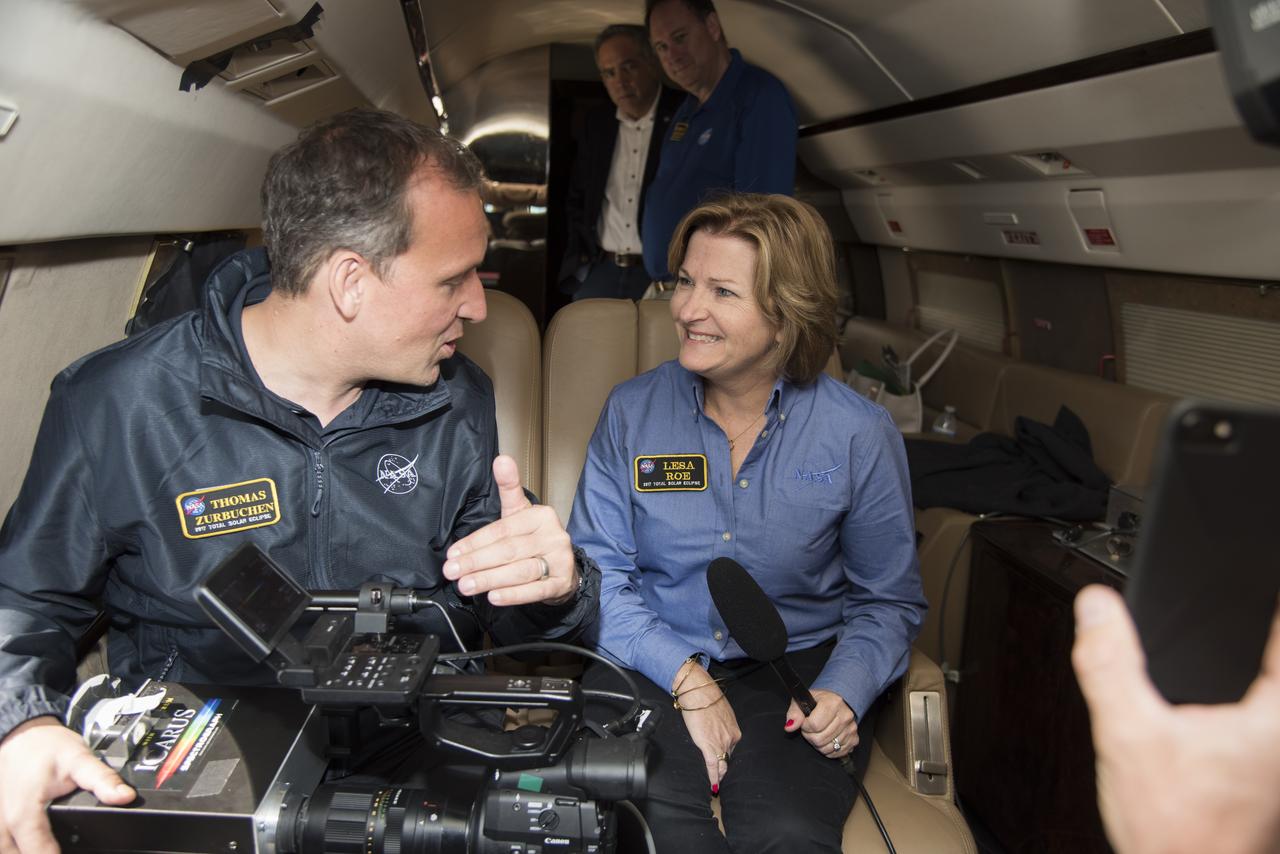NASA's Thomas Zurbuchen, AA for science mission directorate explains to Lesa Roe, acting deputy administrator, how the spectrograph showing different colors correlate to different elements, such as helium, in the Sun's atmosphere. Photo Credit: (NASA/Carla Thomas)