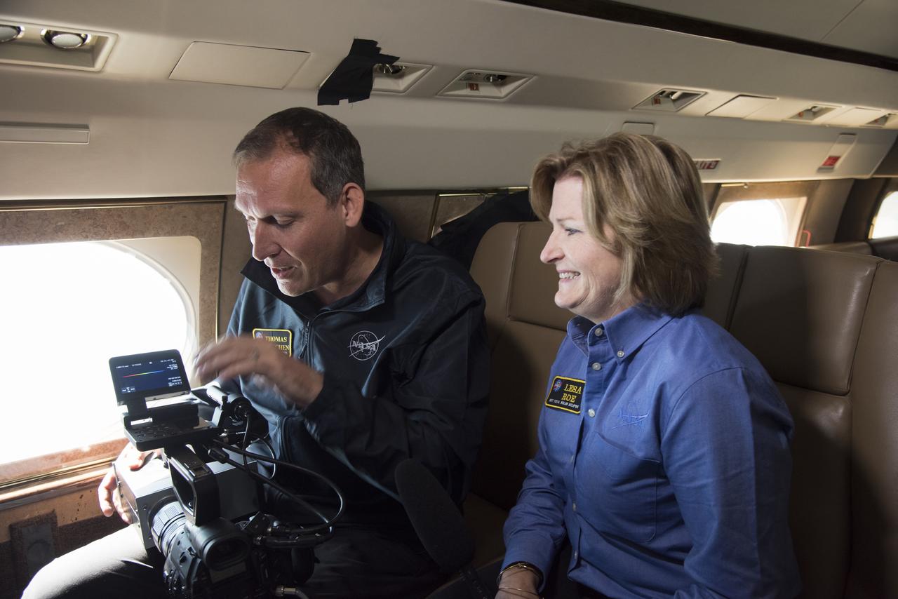 NASA's Thomas Zurbuchen, AA for science mission directorate explains to Lesa Roe, acting deputy administrator, how the spectrograph showing different colors correlate to different elements, such as helium, in the Sun's atmosphere. Photo Credit: (NASA/Carla Thomas)