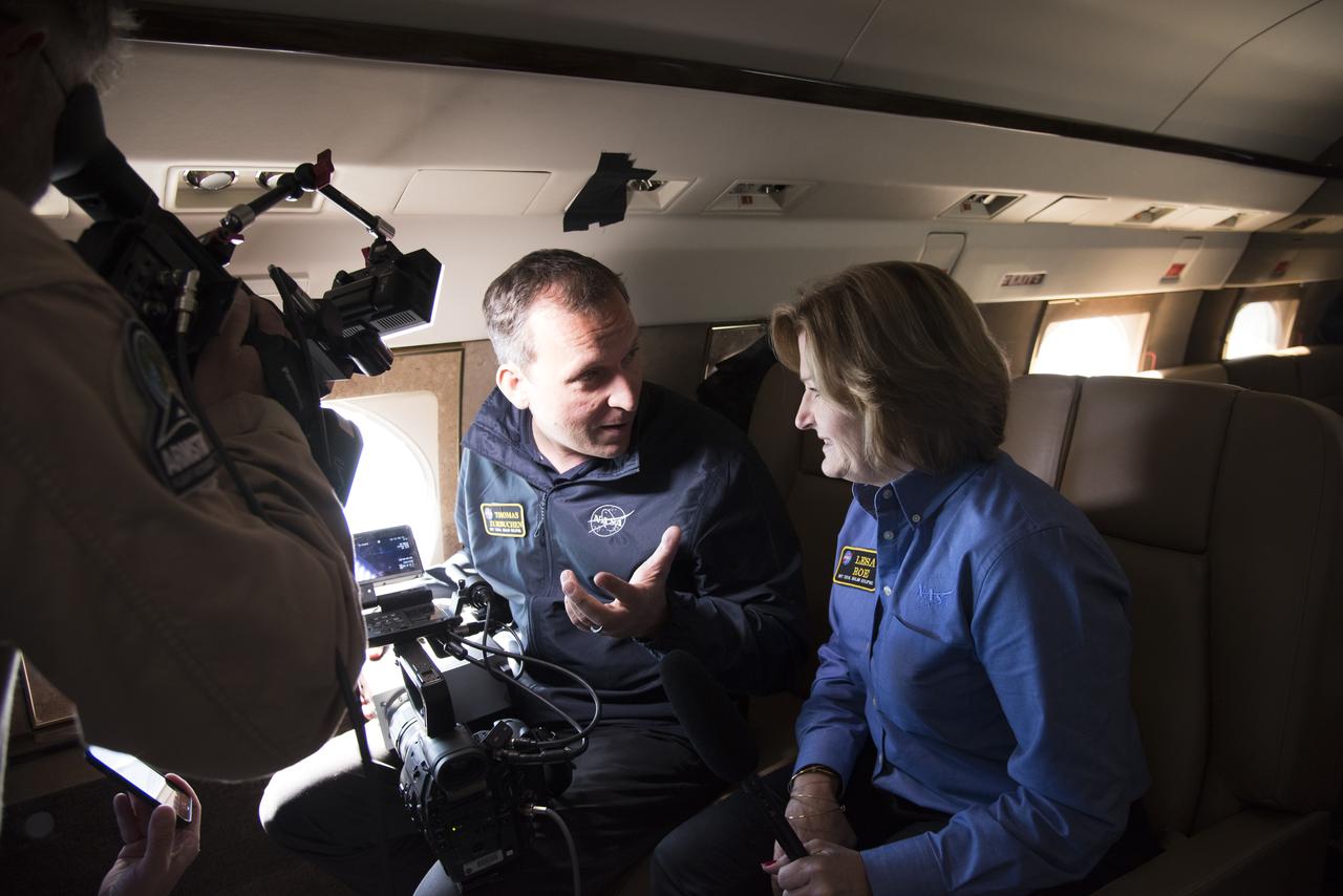 NASA's Thomas Zurbuchen, AA for science mission directorate explains to Lesa Roe, acting deputy administrator, how the spectrograph showing different colors correlate to different elements, such as helium, in the Sun's atmosphere. Photo Credit: (NASA/Carla Thomas)