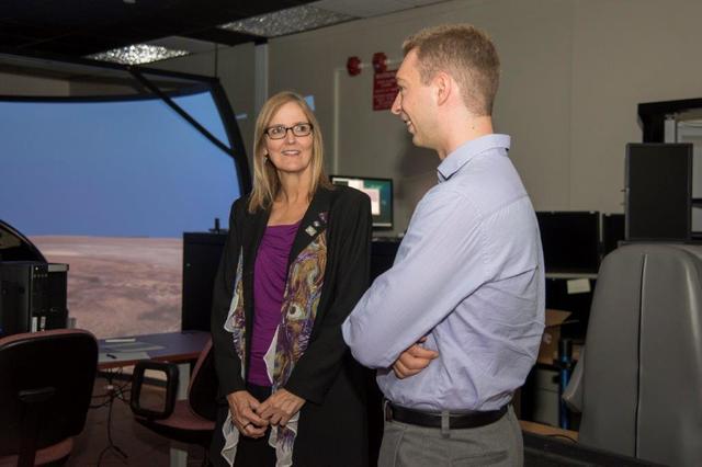 Jesse Brady, an early career NASA employee at NASA’s Armstrong Flight Research Center at Edwards, California, discusses a NASA aircraft simulation project with NASA Acting Deputy Chief Technologist Vicki Crisp. The simulation accesses aircraft controllability with limited pilot visibility, using only front view cameras and side windows.
