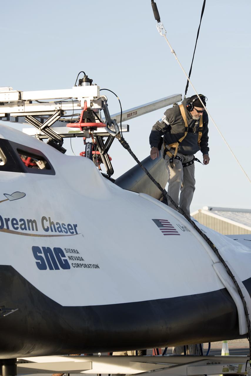 Sierra Nevada Corp’s Dream Chaser crew attached the wires that the helicopter would use to pick it up from NASA’s Armstrong Flight Research Center in California in preparation for its successful approach and landing test Nov. 11, 2017.