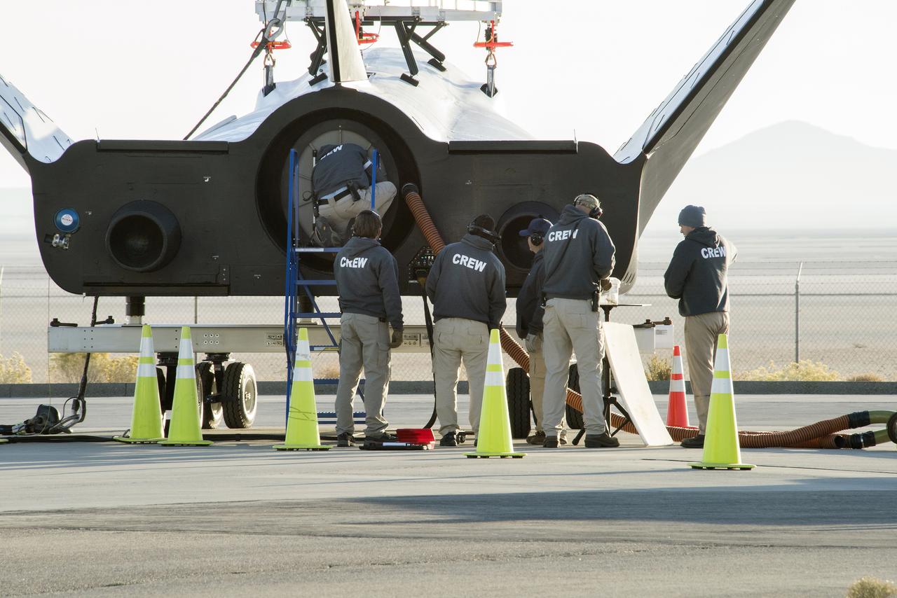 Sierra Nevada Corp’s Dream Chaser crew attached the wires that the helicopter would use to pick it up from NASA’s Armstrong Flight Research Center in California in preparation for its successful approach and landing test Nov. 11, 2017.